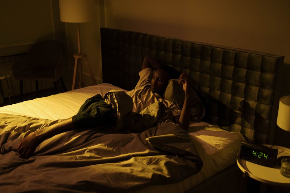 person lying awake in bed at night