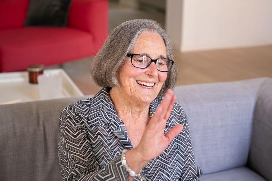 elderly person wearing hearing aid smiling