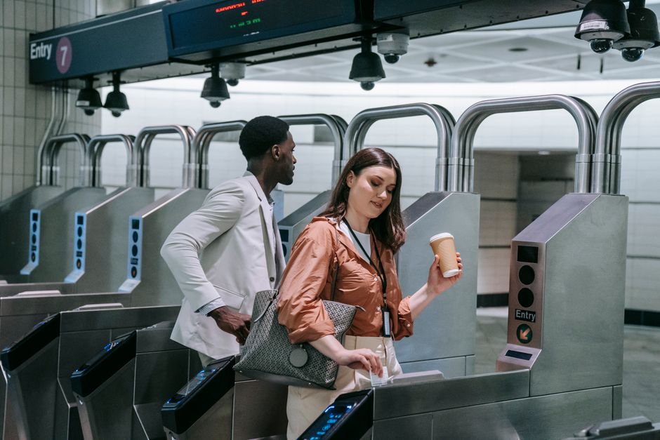 senior couple using subway station turnstile