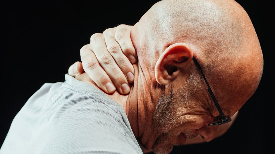 senior person holding painful shoulder