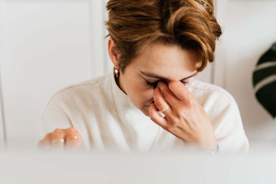 woman with eye twitch tired