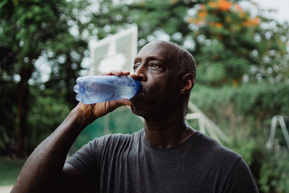 tired man thirsty drinking water
