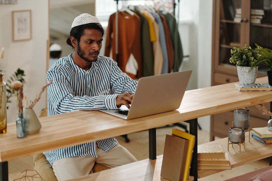 person using laptop at home desk