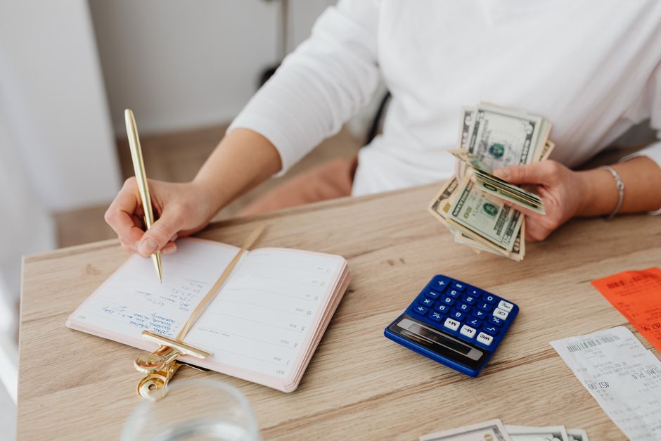 person organizing finances notebook