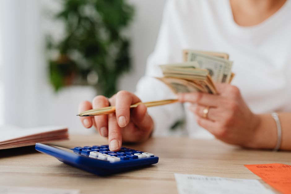 senior person checking finances calculator