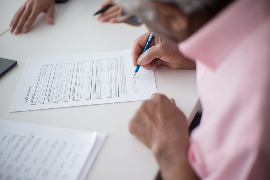 senior person filling out application form