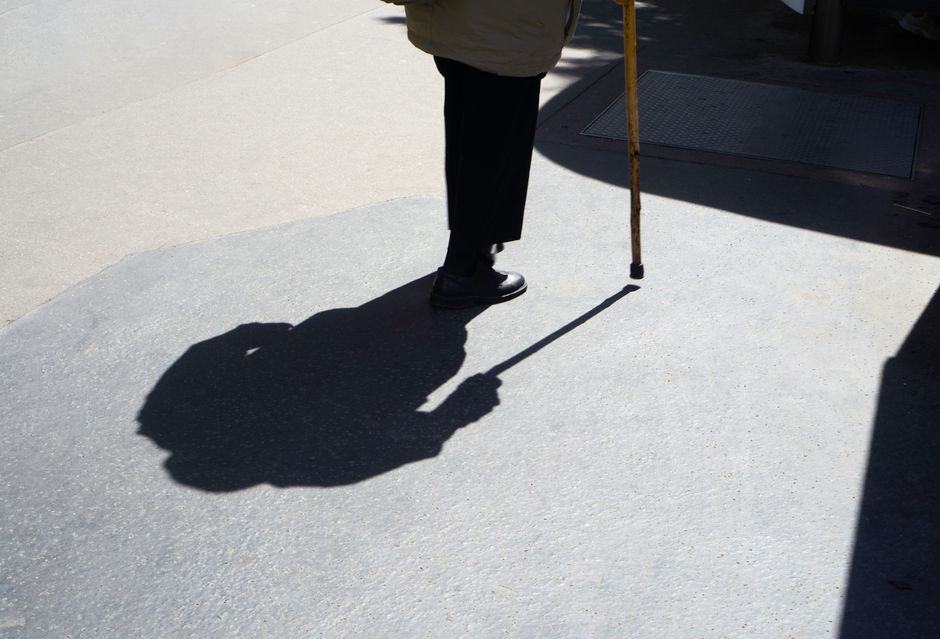 senior person walking outdoors morning