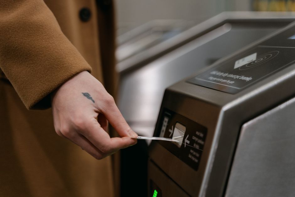 elderly person tapping mobile phone at subway gate