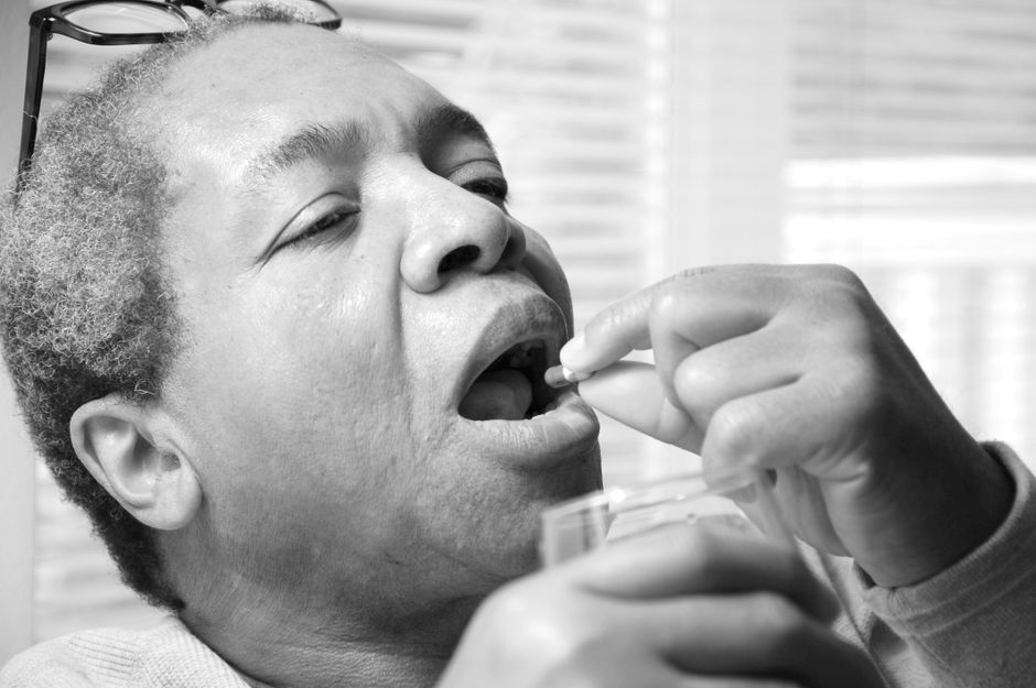 senior woman taking medicine with water