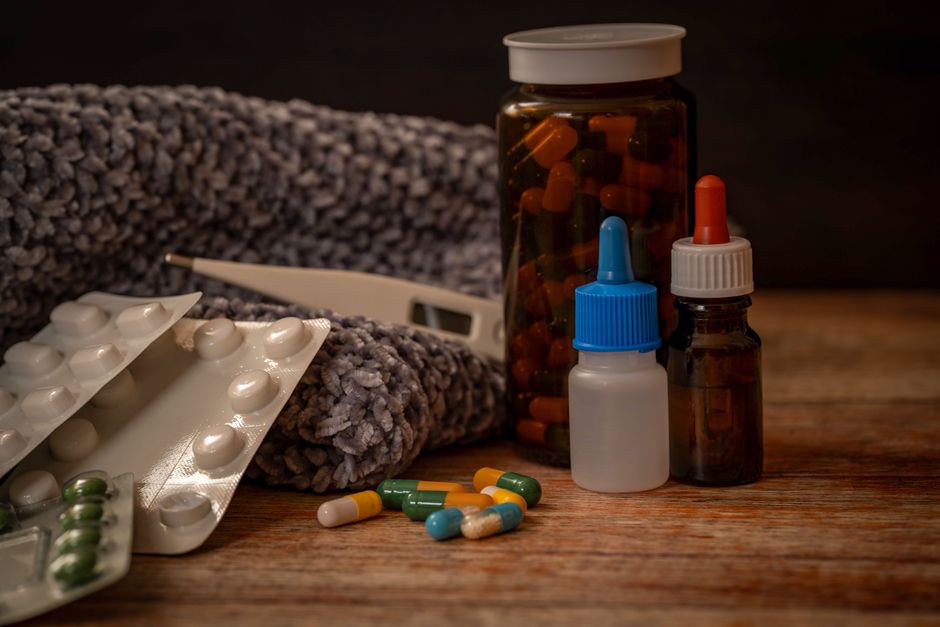 pile of old medicine pills and bottles at home