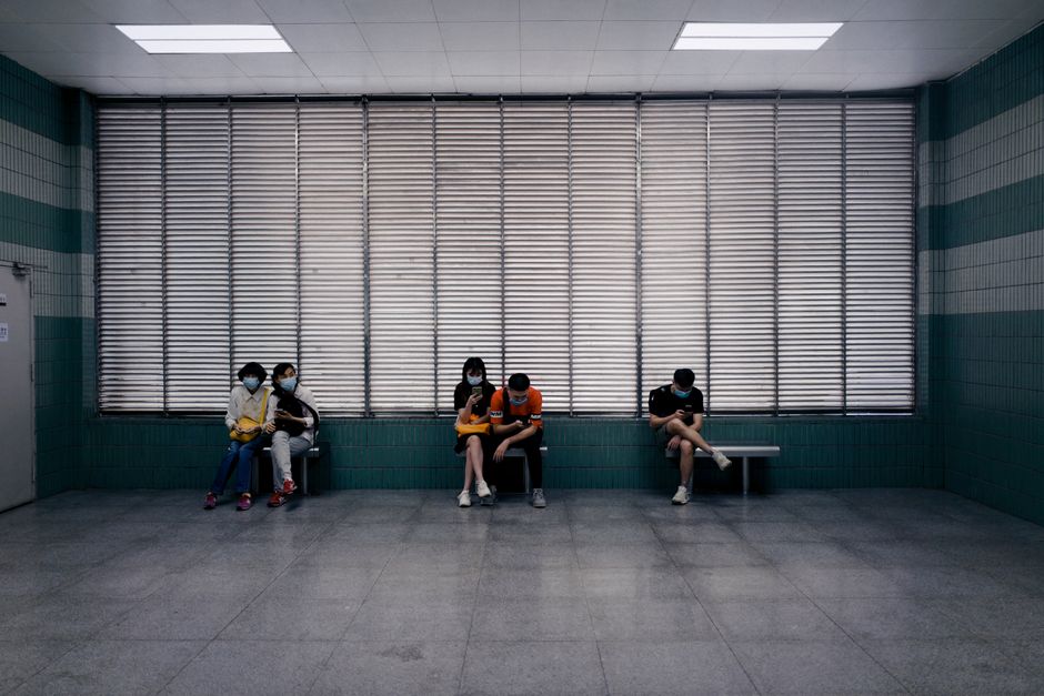 person using smartphone hospital waiting room