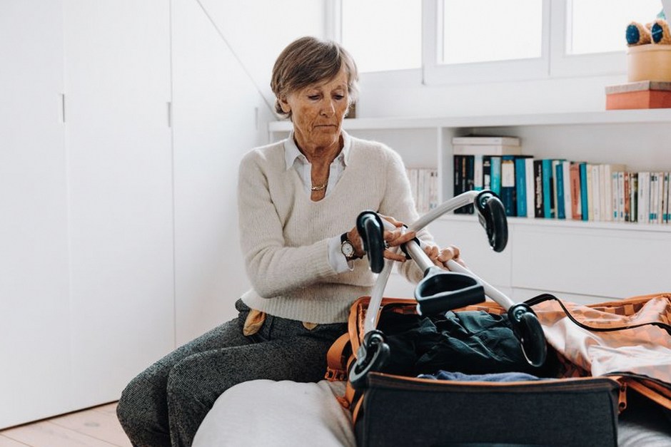 senior couple packing suitcase for travel