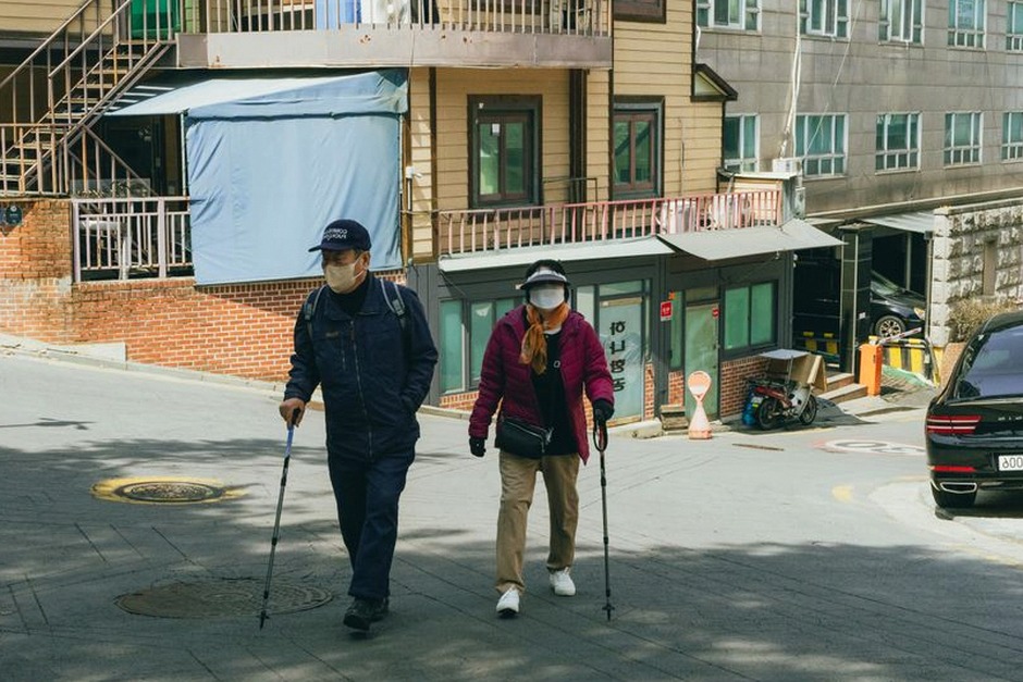 elderly korean couple looking at brochure