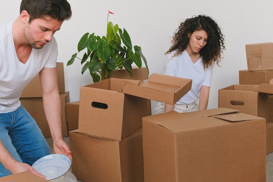 senior couple packing moving boxes