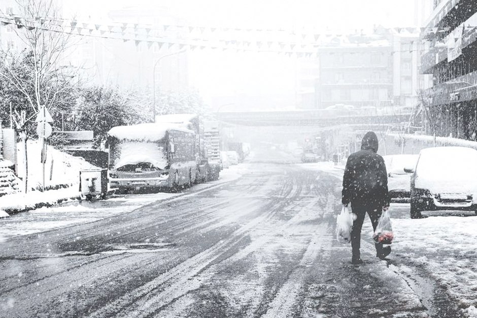elderly person walking icy street winter