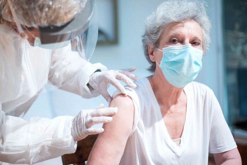senior citizen receiving vaccine injection