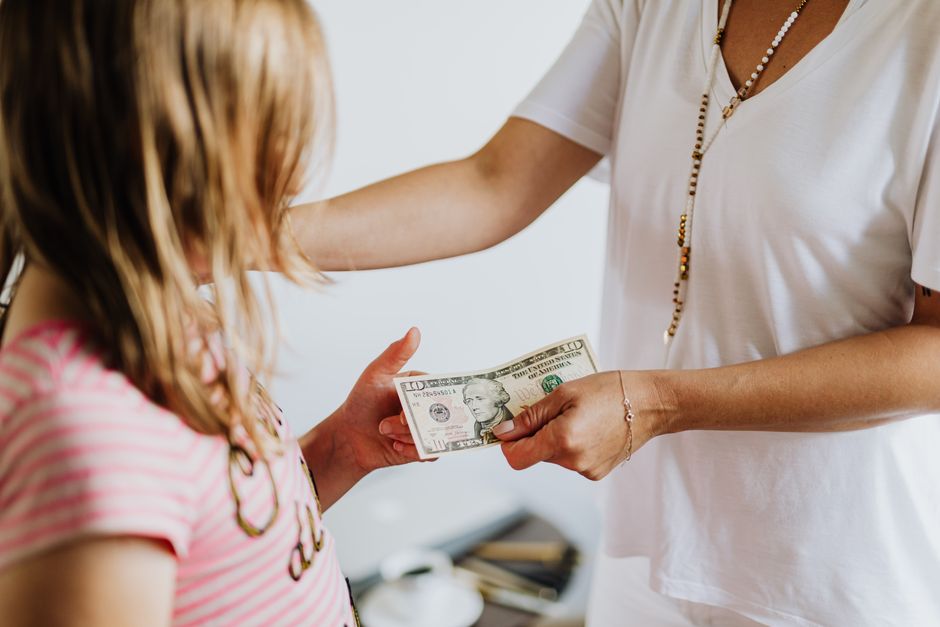 parent giving money to child