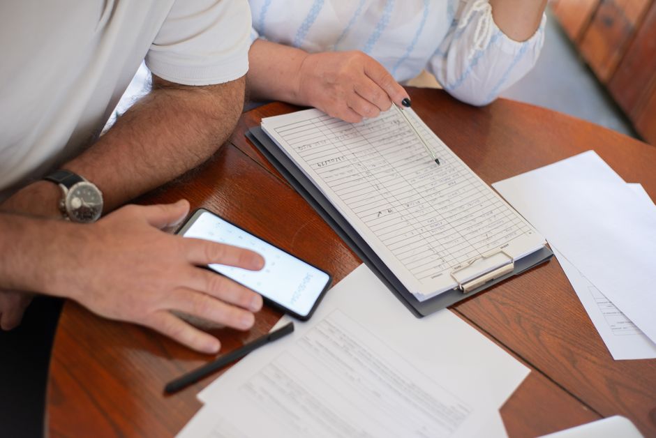 korean senior couple reviewing bills at home