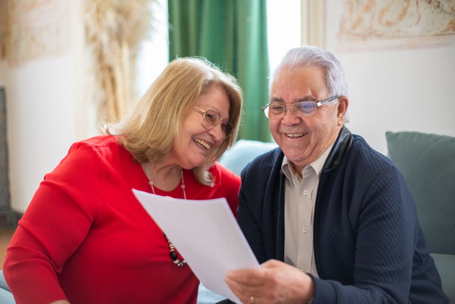 senior couple looking at apartment brochure