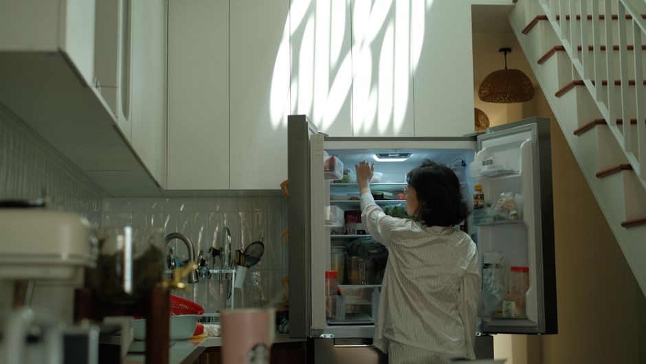 elderly korean woman opening refrigerator