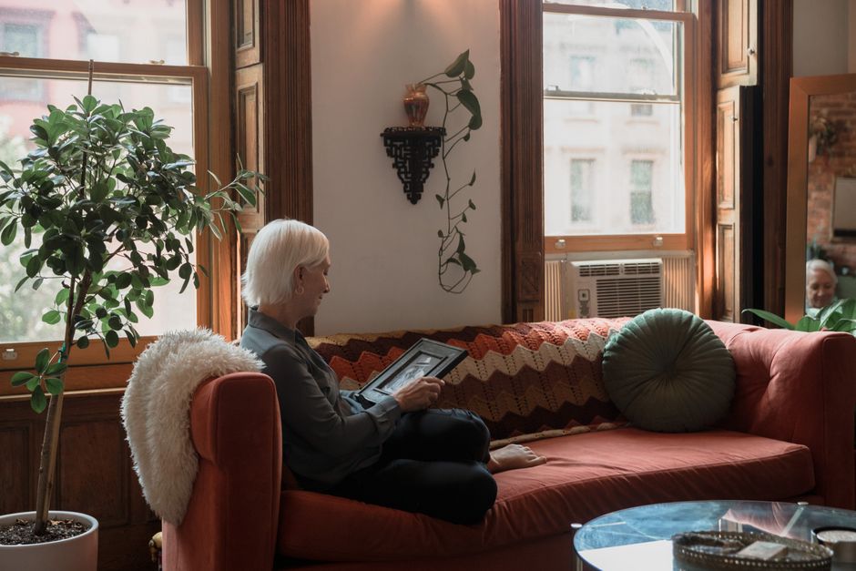 senior woman resting near air conditioner