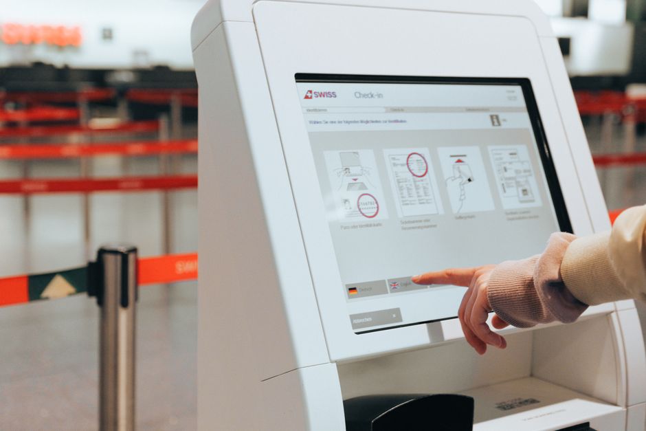 elderly person using self service kiosk screen