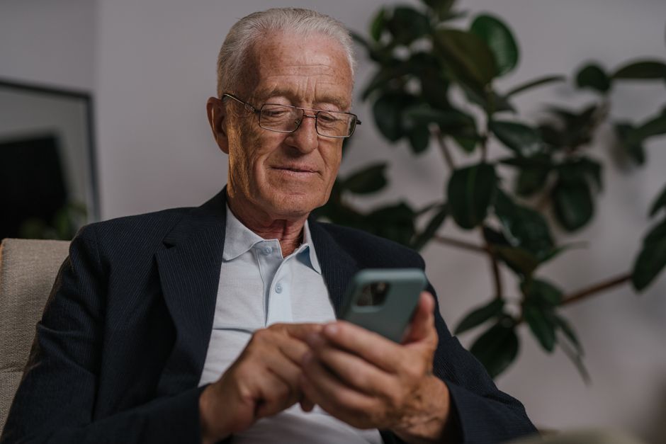senior citizen using smartphone welfare app