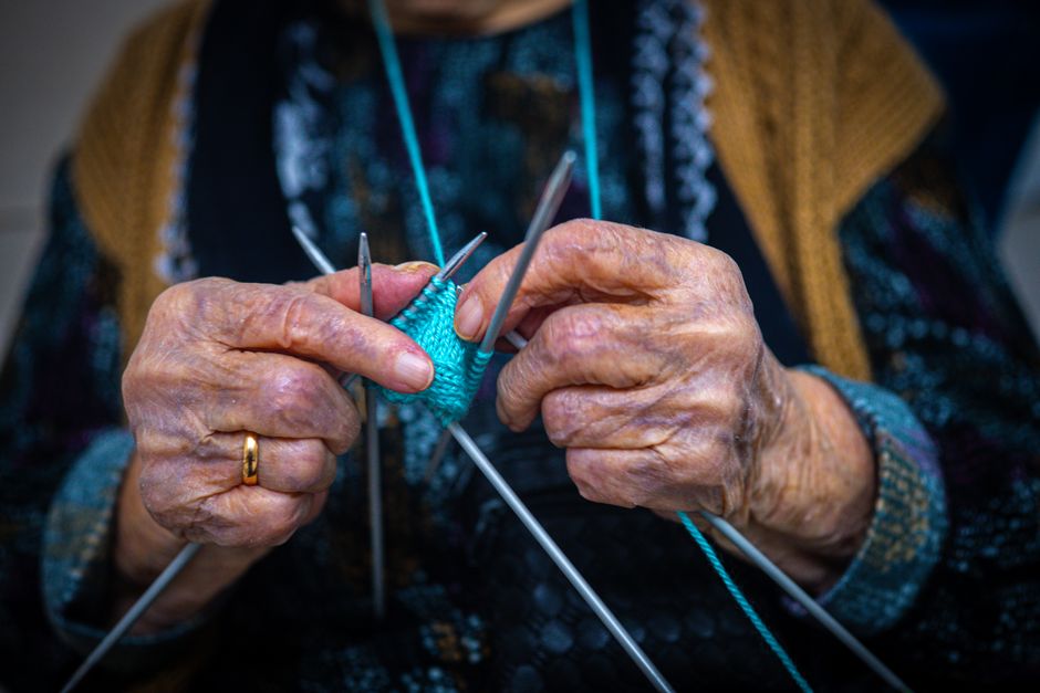 elderly hands knitting wool yarn