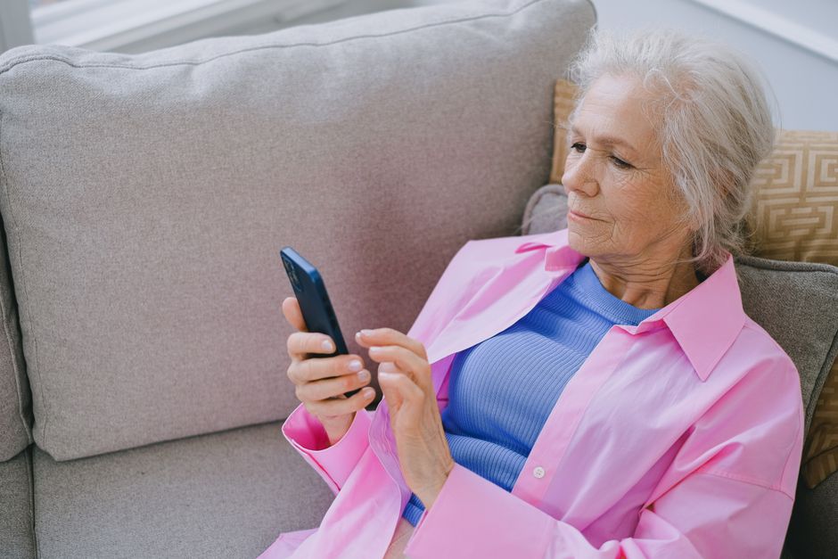 elderly person using smartphone app