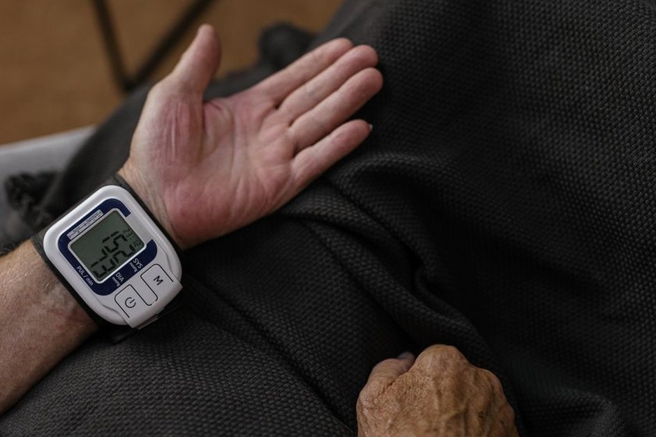 elderly person checking blood pressure at home