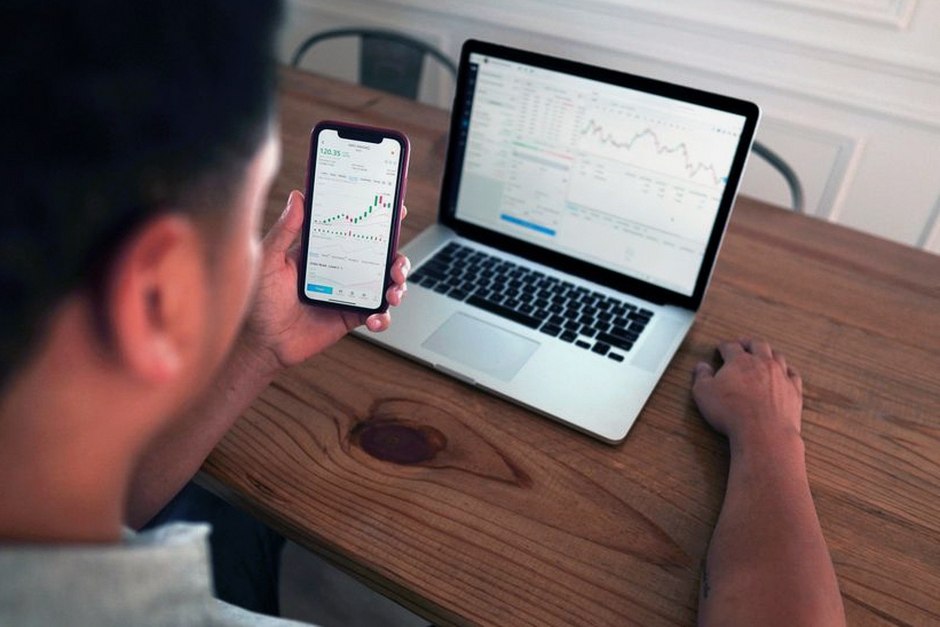 person checking investment portfolio smartphone