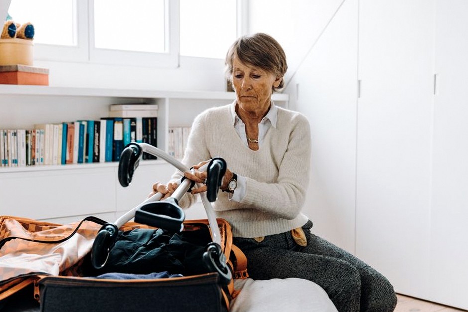 senior travelers packing suitcase medicine
