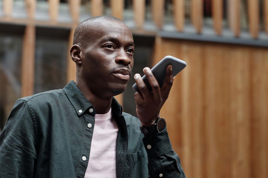 senior using voice assistant on smartphone