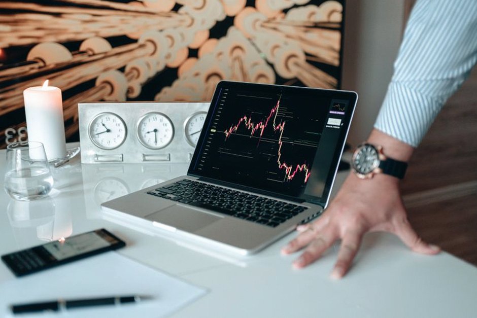 investor analyzing charts on laptop
