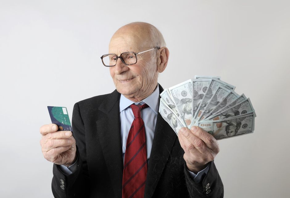 senior man holding id card
