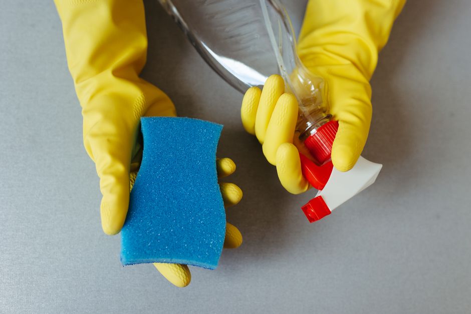 cleaning supplies rubber gloves spray bottle