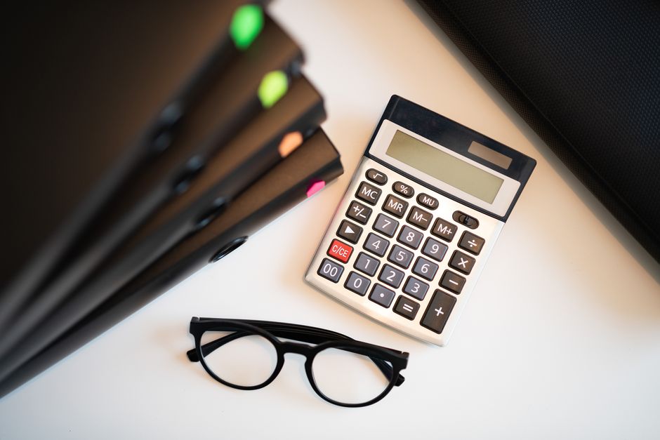 calculator and loan documents on desk