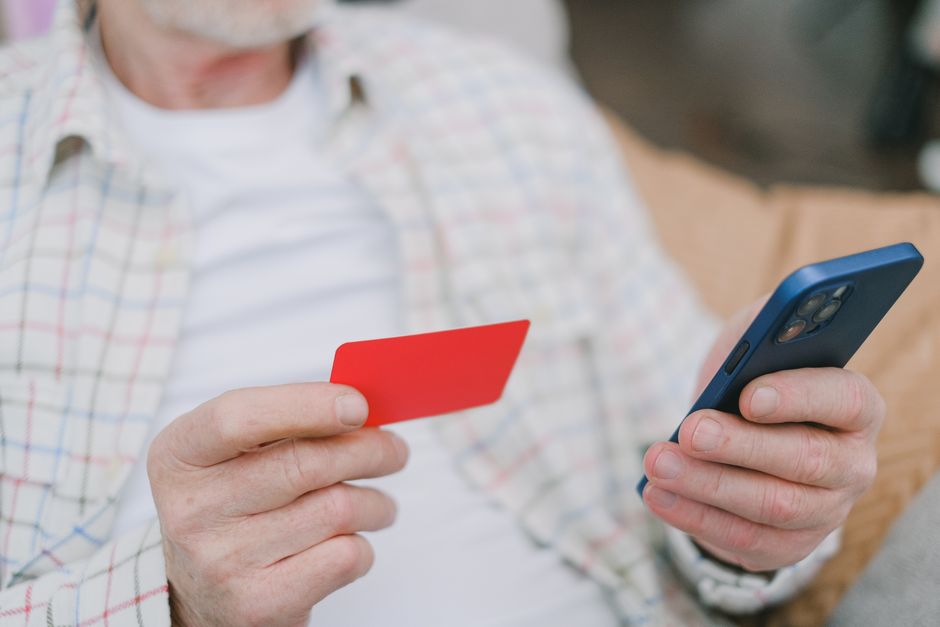 elderly person using banking app smartphone
