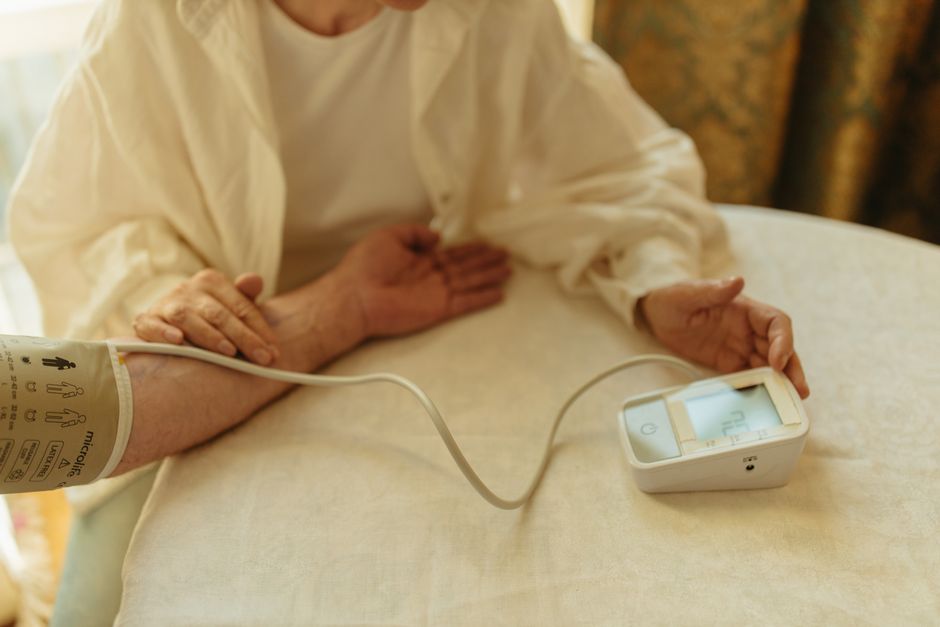 person measuring blood pressure at home