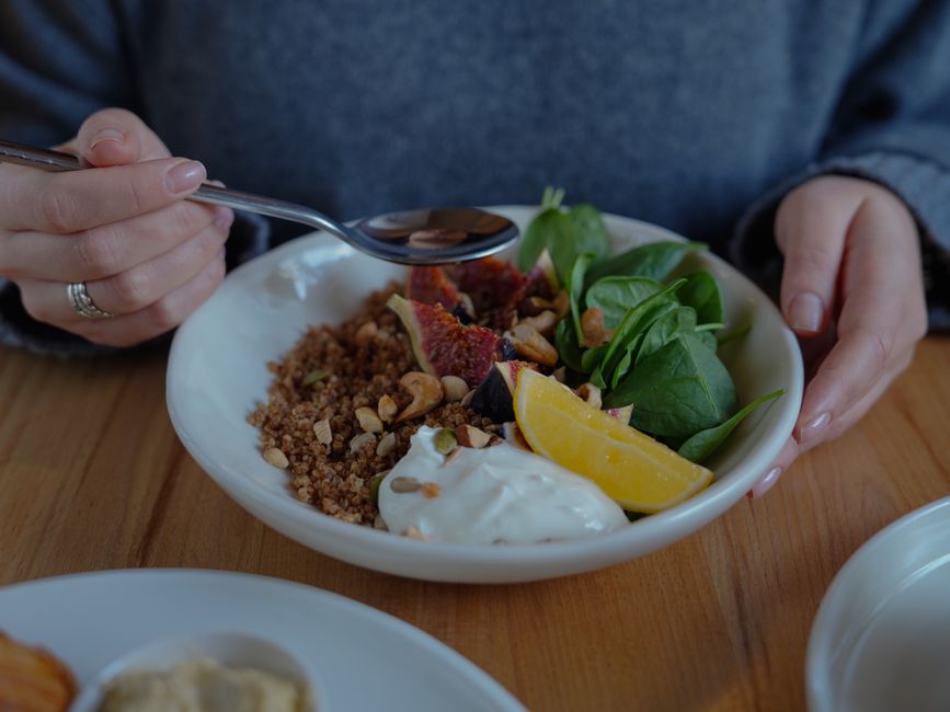 leafy greens nuts and healthy food on table