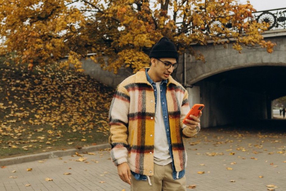 young korean man checking phone finance