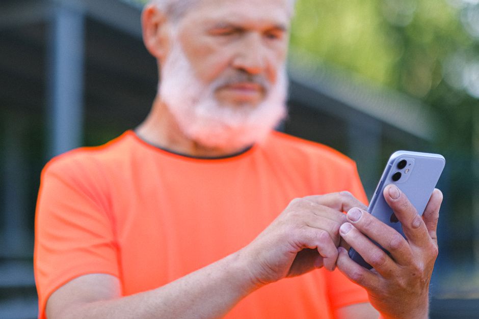 senior person checking smartphone safely