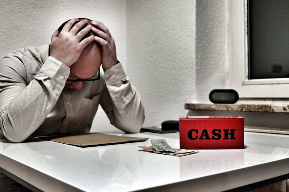 worried person looking at savings account passbook