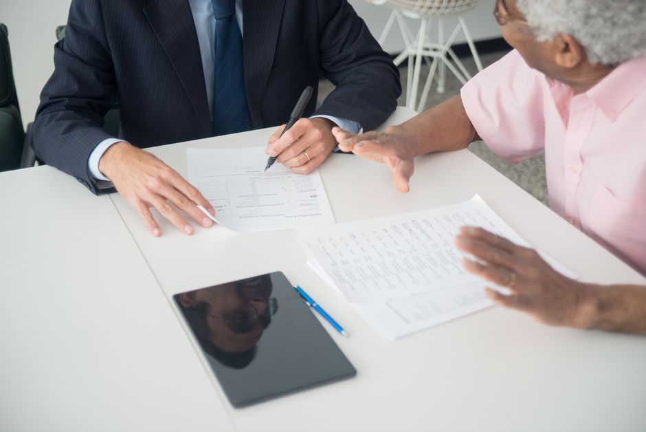 elderly woman talking with insurance consultant