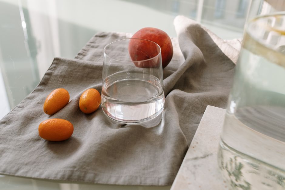 glass of water and korean summer fruits table