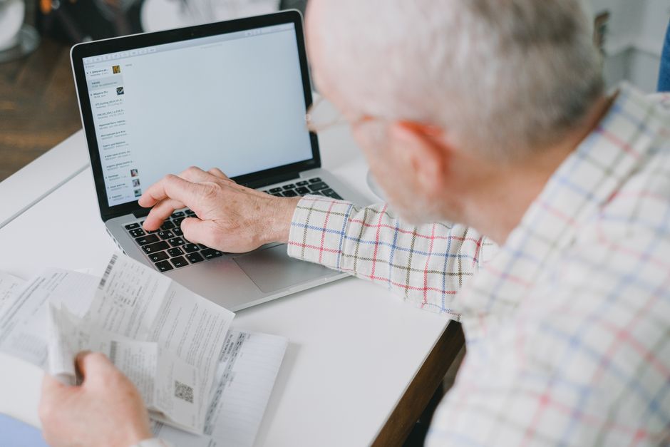 senior person using laptop finance