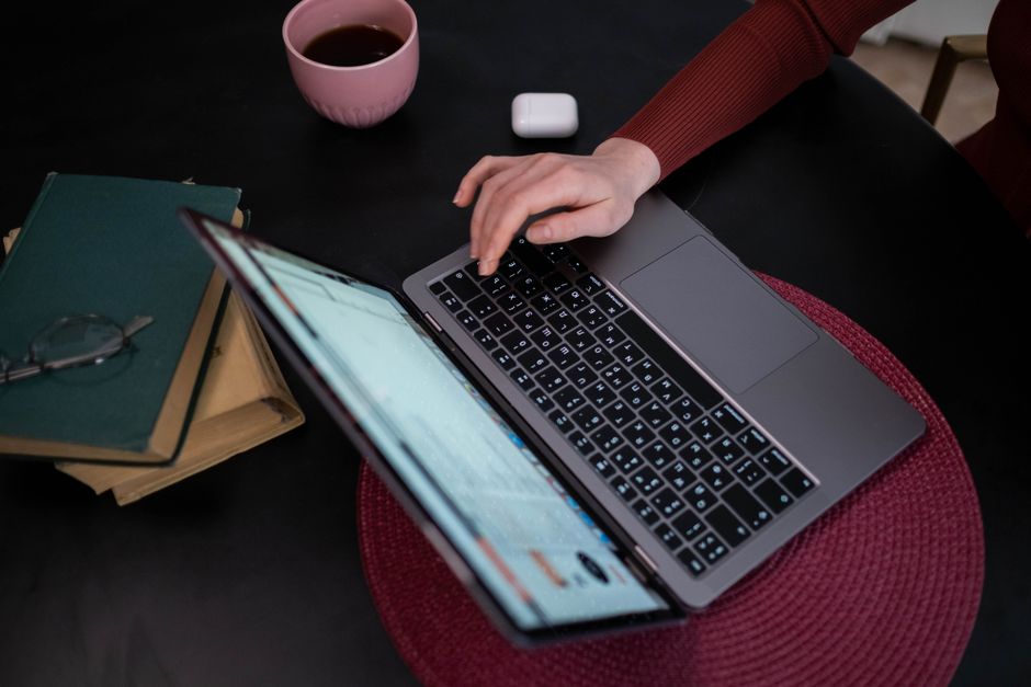 person booking train ticket on laptop computer