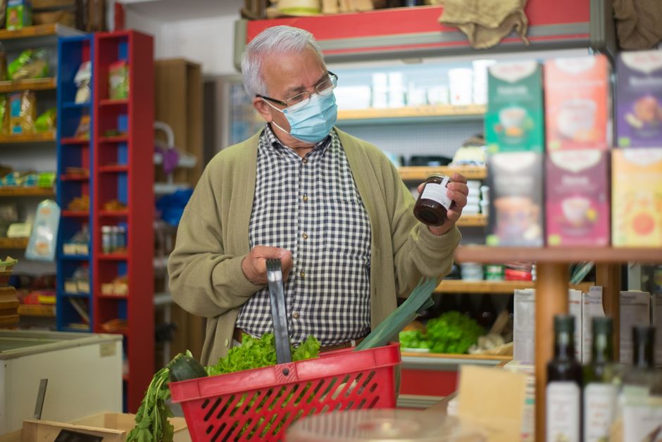 senior man checking food expiration date
