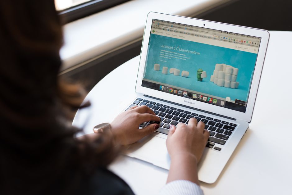 person registering on government website laptop