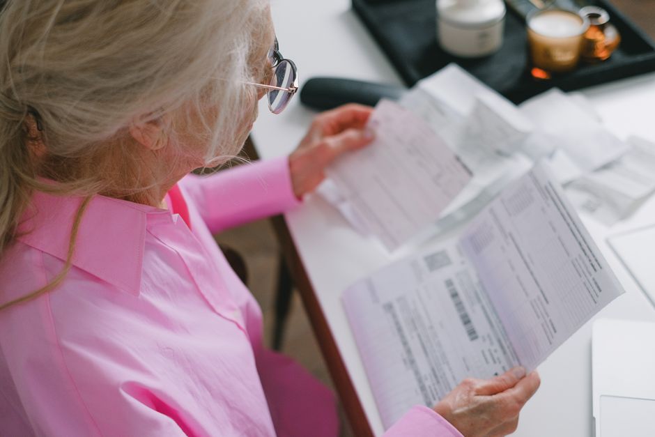 korean senior checking documents desk